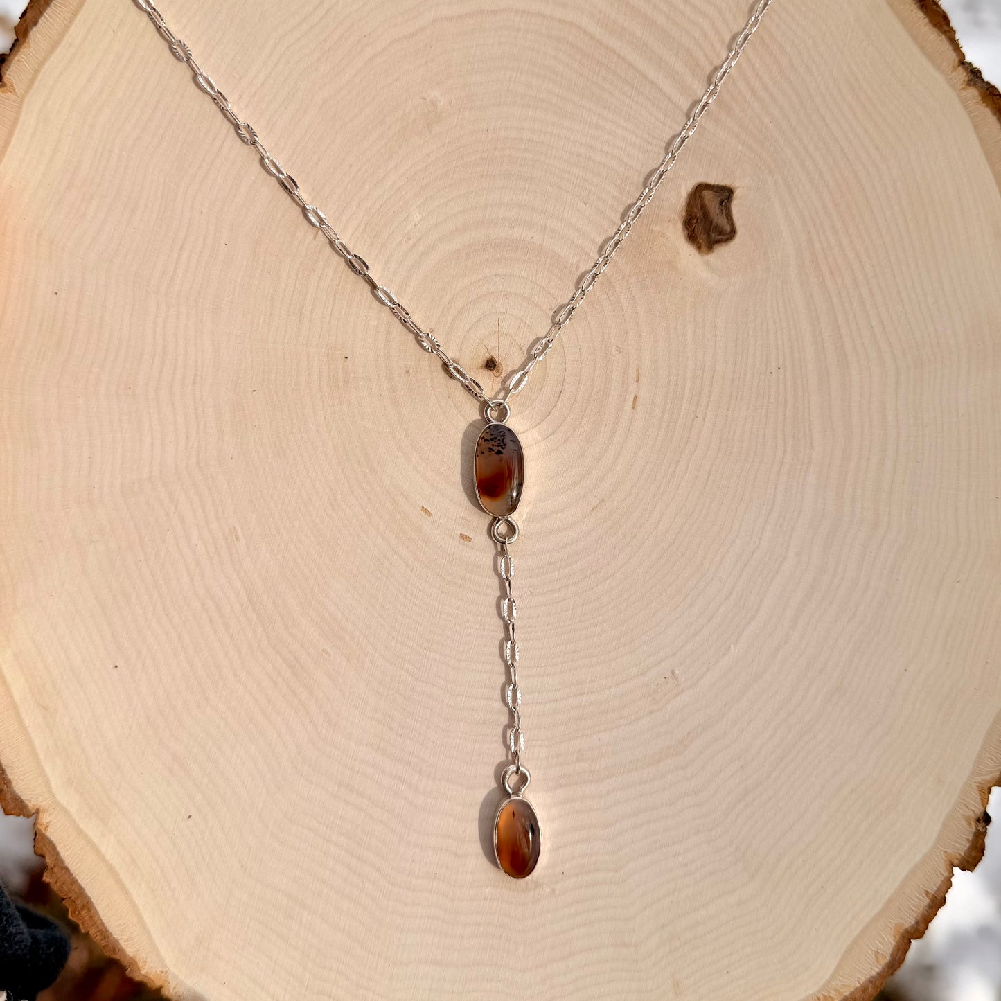 Necklace with amber pendant on a wooden surface
