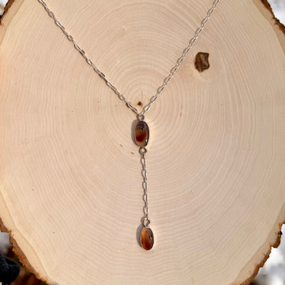 Necklace with amber pendant on a wooden surface